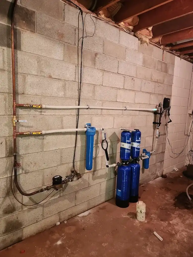 Basement wall with new supply piping and equipment in a Clifton, NJ home