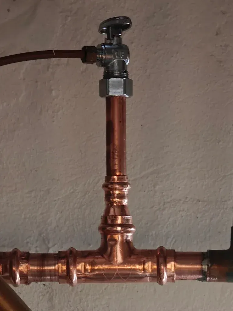 Fresh copper tee and fittings soldered in during an emergency pipe repair in Clifton, NJ