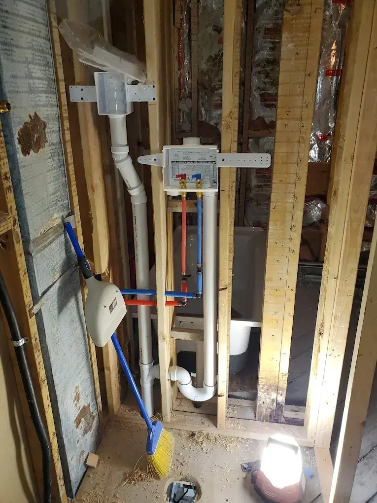New PVC drain, waste and vent piping with a cleanout in an open wall in Clifton, NJ