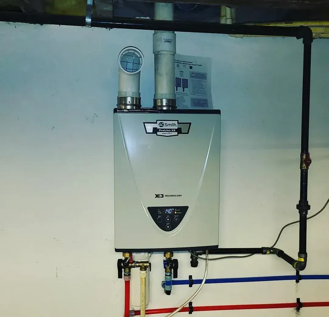 Wall-mounted high-efficiency tankless water heater with new gas and water connections in a Clifton home